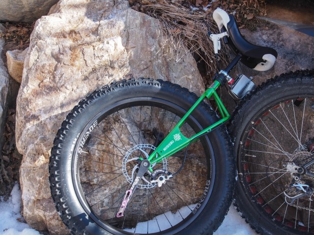 A fat unicycle complete with disc brake and a flask cage.