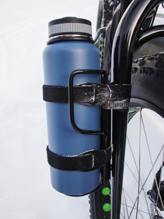 Hardware store velcro straps securely hold this large bottle on the Salsa Anything Cage.