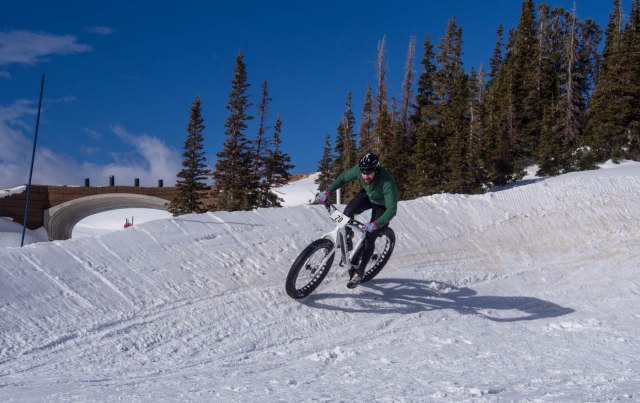 Mike Barklow rounding the large berm and the start/finish area.