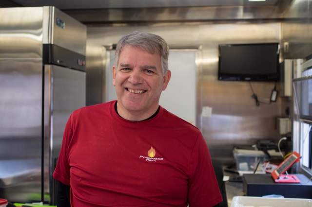 The man behind the pizza.