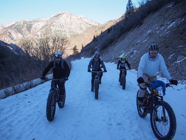 Bullet, Jess, and others riding up the road.