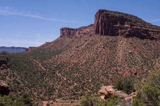 Foreground: the bottom of Rose Garden Hill; the route heads up to the saddle to the left before dropping into Fisher Valley. The ridge in the distance separates Fisher and Castle Valleys